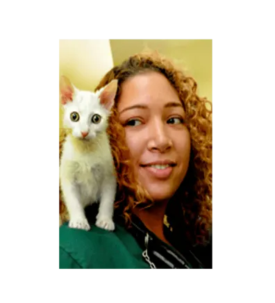 Dr. Christina East's staff photo from Riverside Animal Hospital South where there's a white kitten on her right shoulder